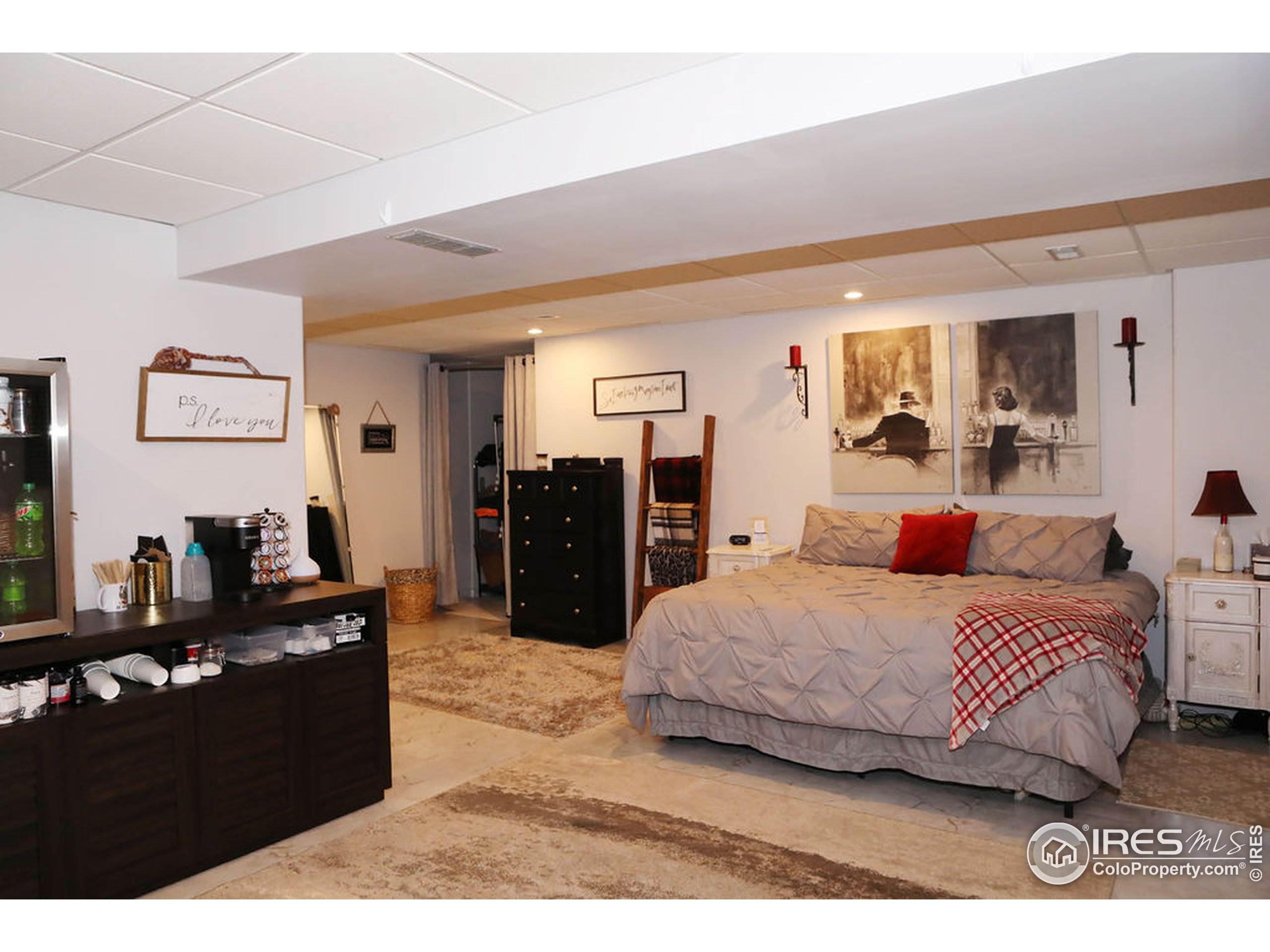 1150 County Rd M 5/10 Wiggins, CO 80654 - Photo 13 of 31 a bedroom with a bed and dresser