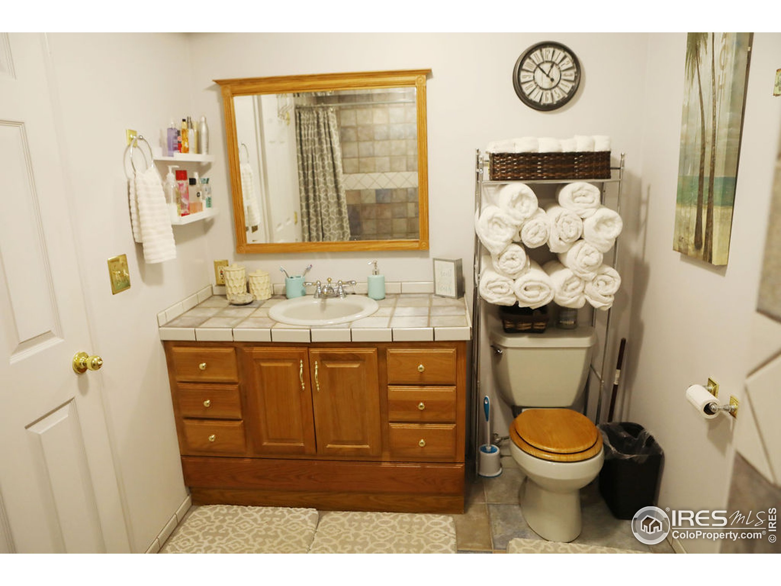 1150 County Rd M 5/10 Wiggins, CO 80654 - Photo 15 of 31 a bathroom with a toilet sink and mirror
