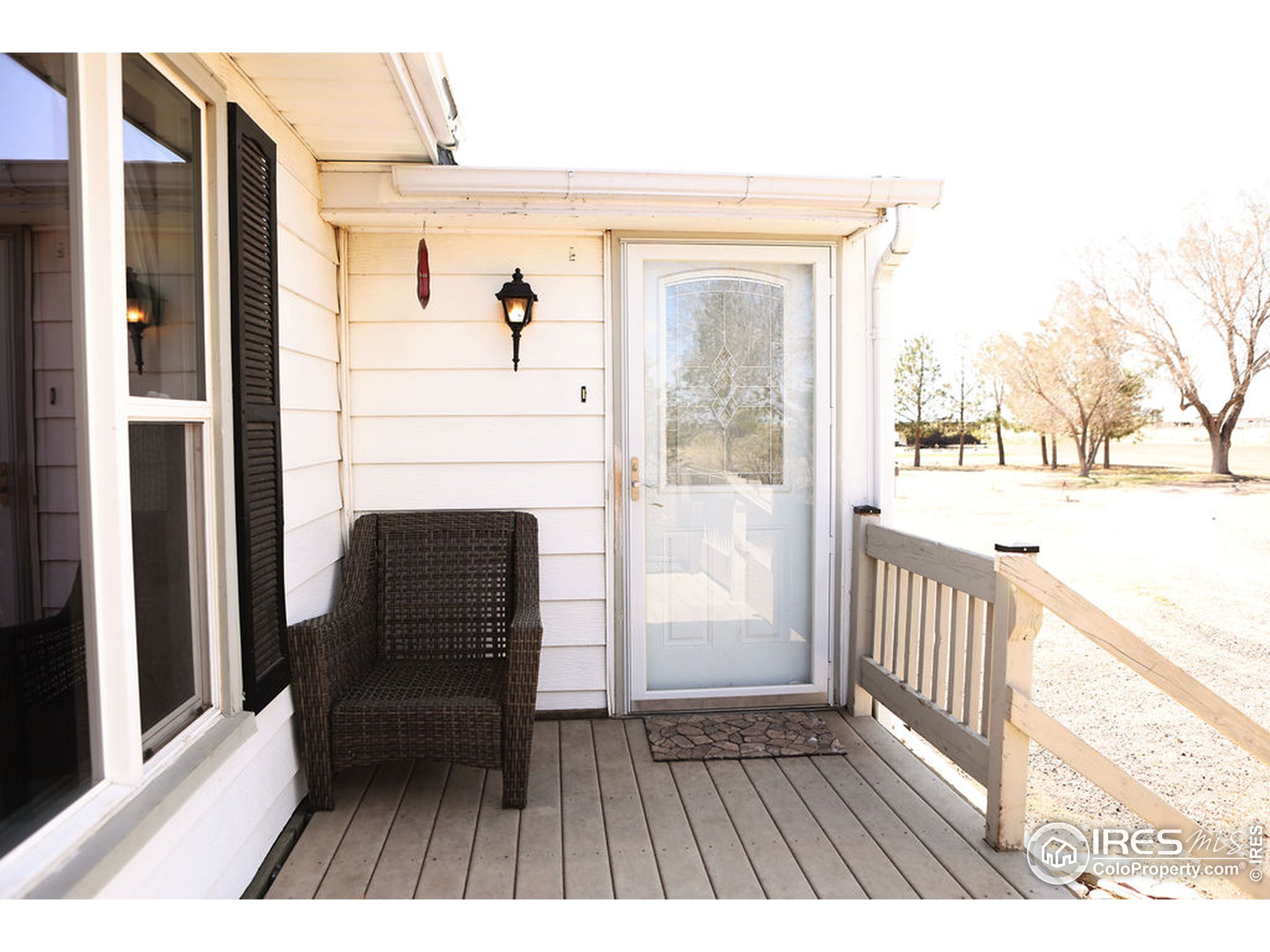 1150 County Rd M 5/10 Wiggins, CO 80654 - Photo 2 of 31 a view of a balcony with furniture and wooden floor