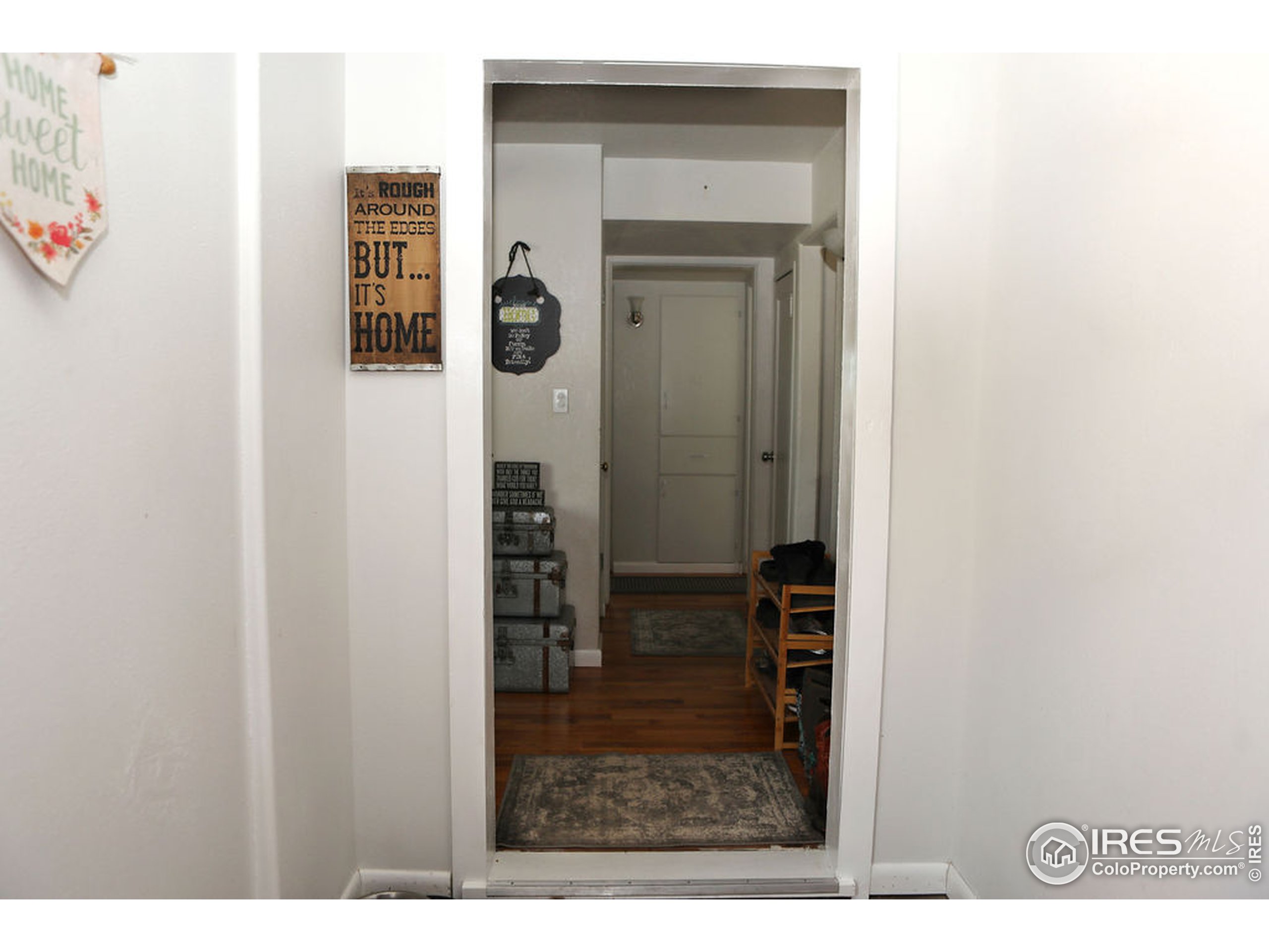 1150 County Rd M 5/10 Wiggins, CO 80654 - Photo 3 of 31 a view of hallway with wooden floor