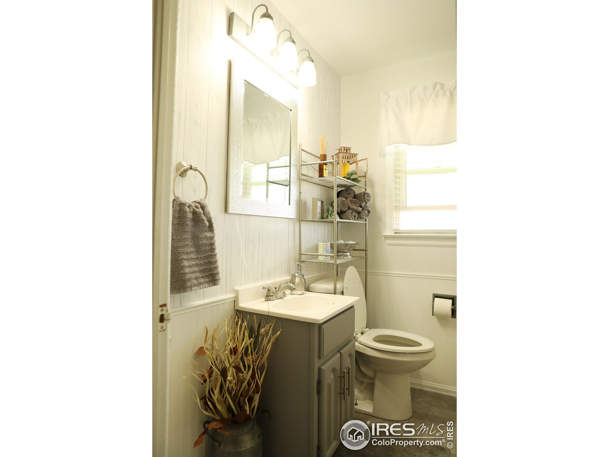 1150 County Rd M 5/10 Wiggins, CO 80654 - Photo 9 of 31 a bathroom with a sink toilet and mirror