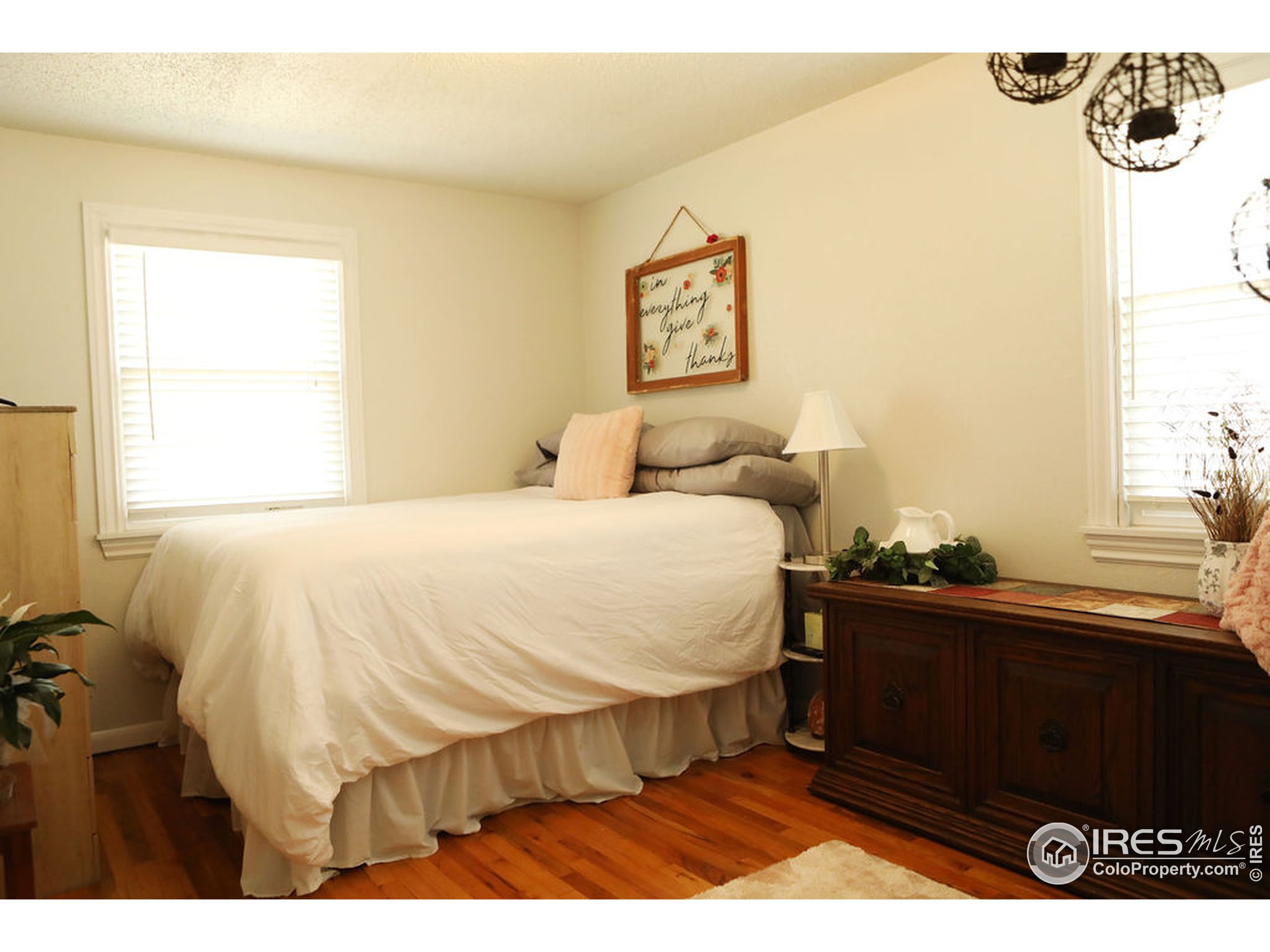 1150 County Rd M 5/10 Wiggins, CO 80654 - Photo 10 of 31 a bed sitting in a bedroom next to a window