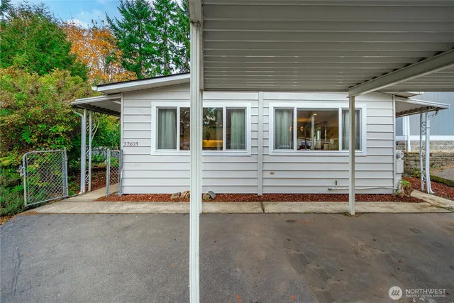 a view of house with small yard and wooden fence