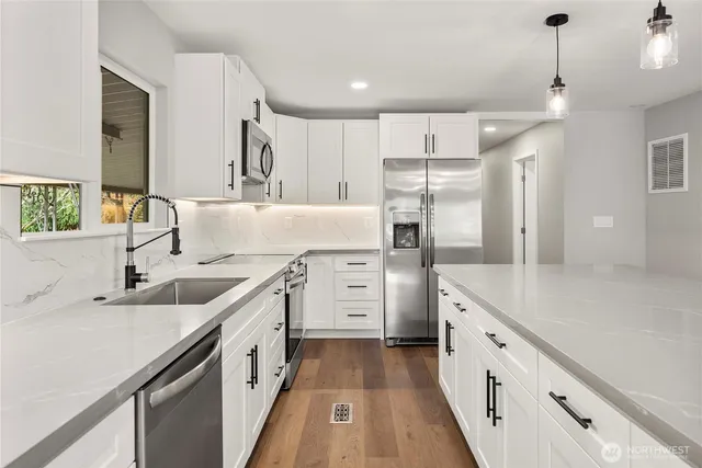 a kitchen with white cabinets and white appliances