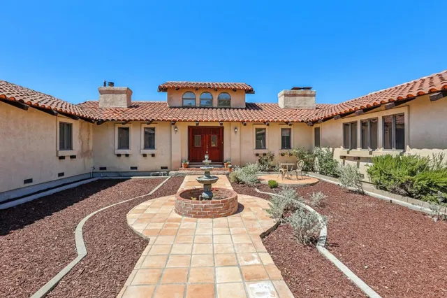 a front view of a house with sitting area