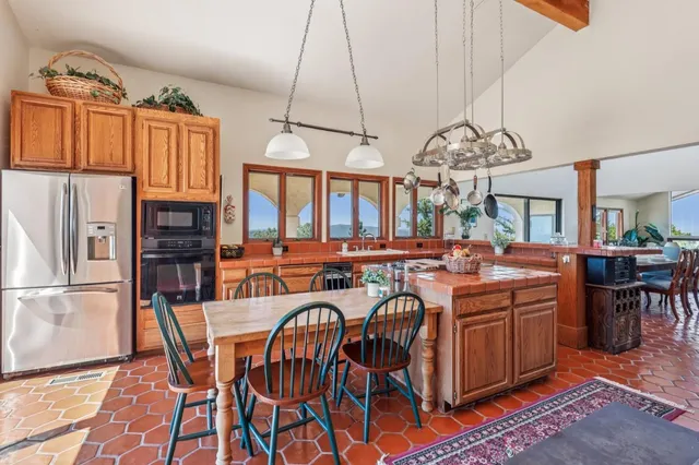 a view of a dining room with furniture a chandelier and wooden floor
