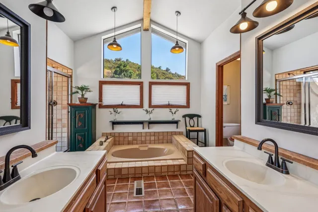 a bathroom with a granite countertop sink and a large mirror