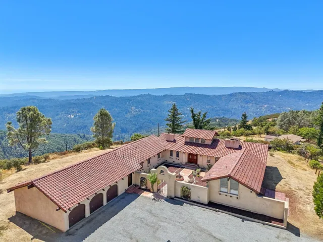 an aerial view of a house with ocean view