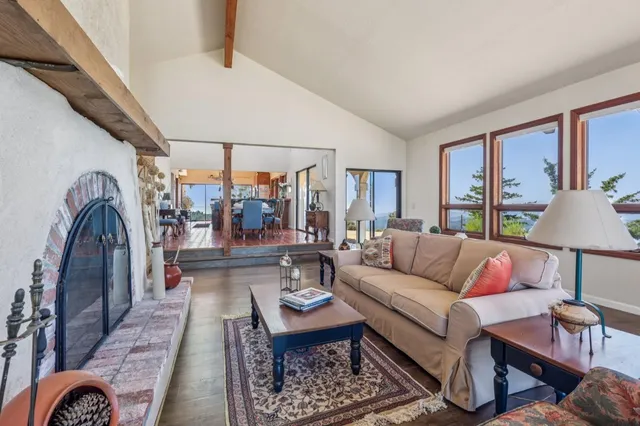 a living room with furniture fireplace and a table