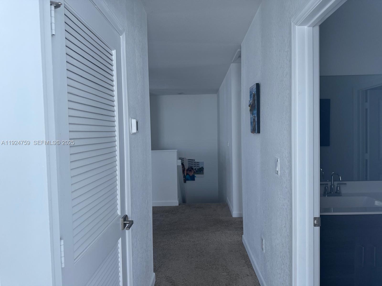 13201 Southwest 269th Terrace Homestead, FL 33032 - Photo 18 of 33 a view of a hallway with closet and living room