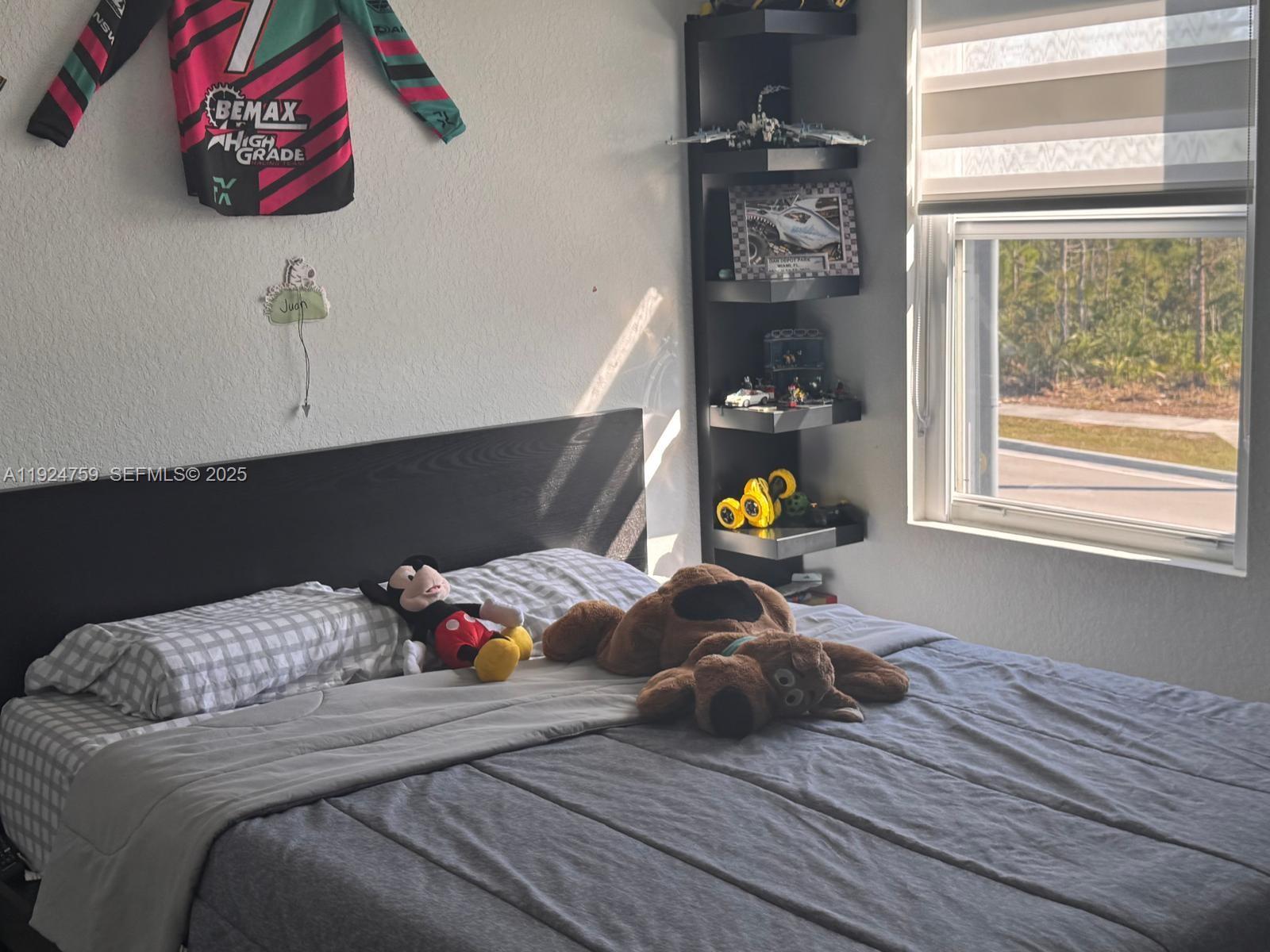 13201 Southwest 269th Terrace Homestead, FL 33032 - Photo 21 of 33 a bedroom with a bed and a window