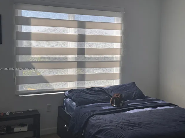 a view of bedroom with a window