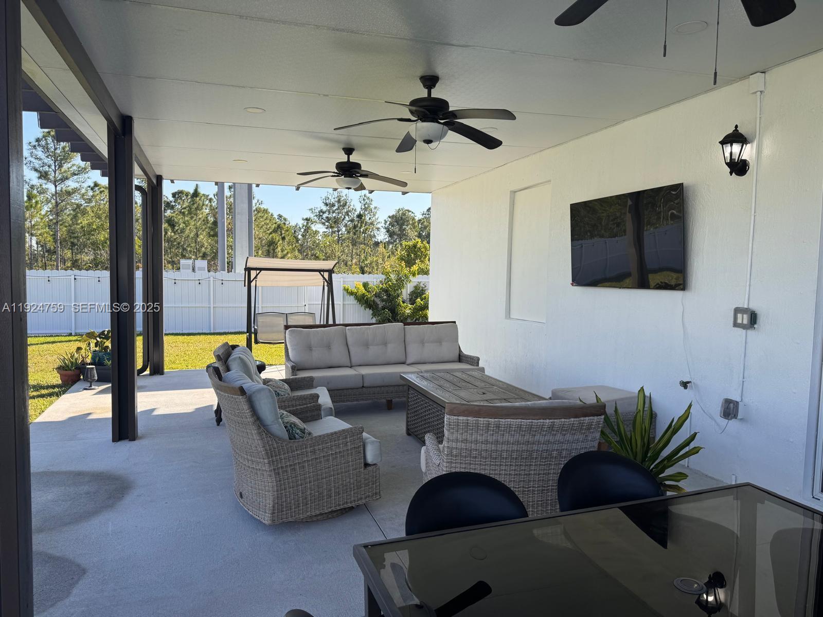 13201 Southwest 269th Terrace Homestead, FL 33032 - Photo 28 of 33 a living room with furniture and a flat screen tv
