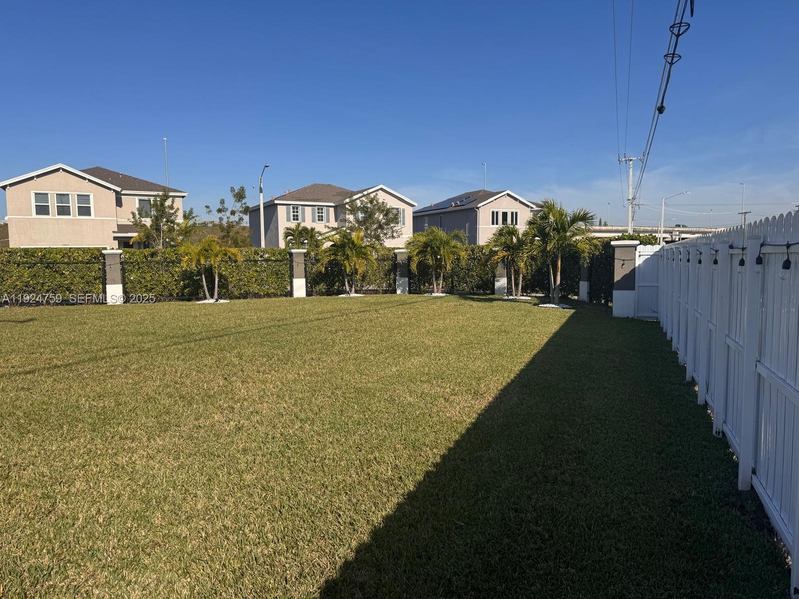 13201 Southwest 269th Terrace Homestead, FL 33032 - Photo 30 of 33 a view of swimming pool in front of residential houses