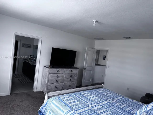 a bedroom with a bed and a television in it