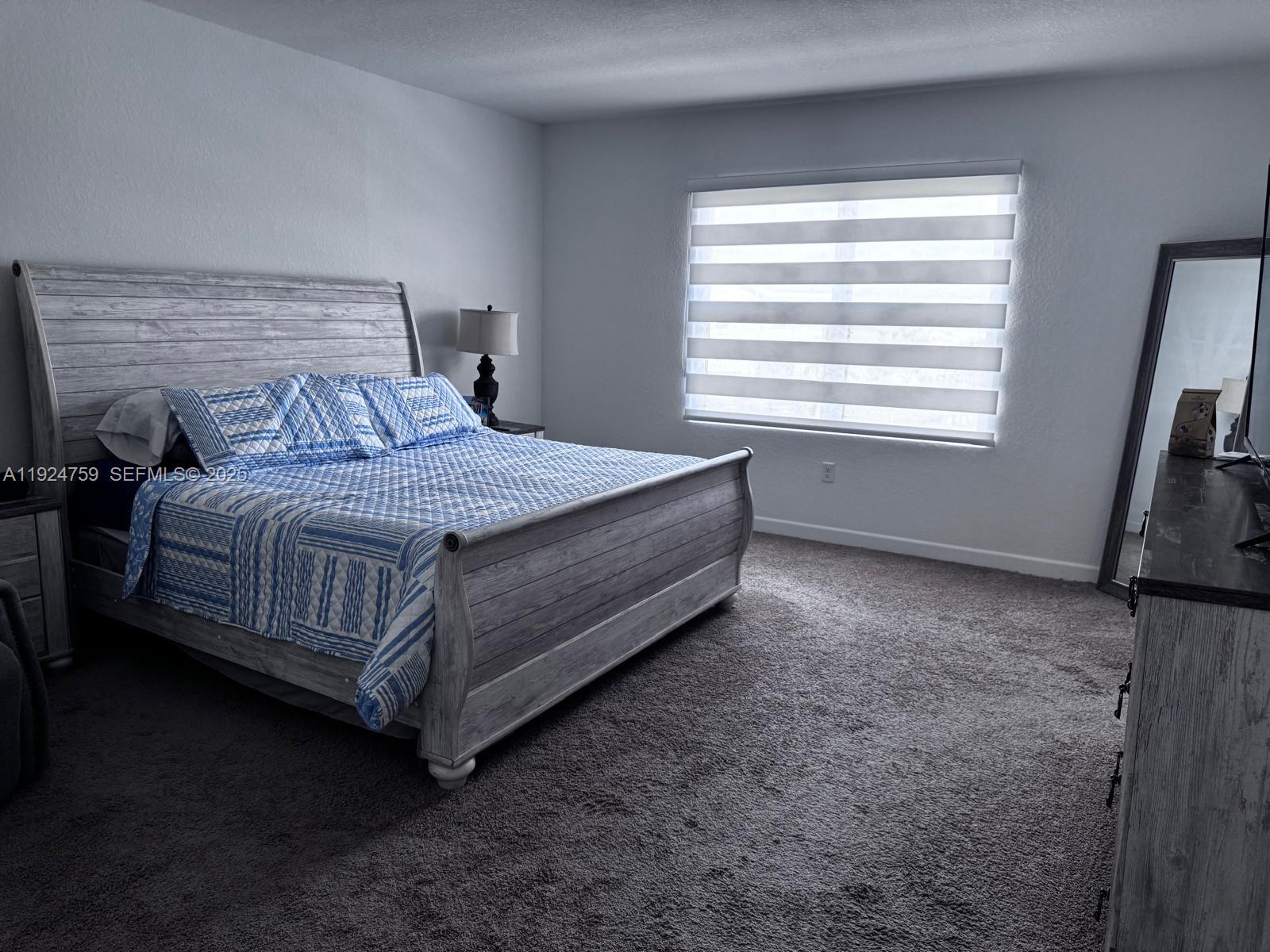 13201 Southwest 269th Terrace Homestead, FL 33032 - Photo 6 of 33 a bedroom with a bed and a window