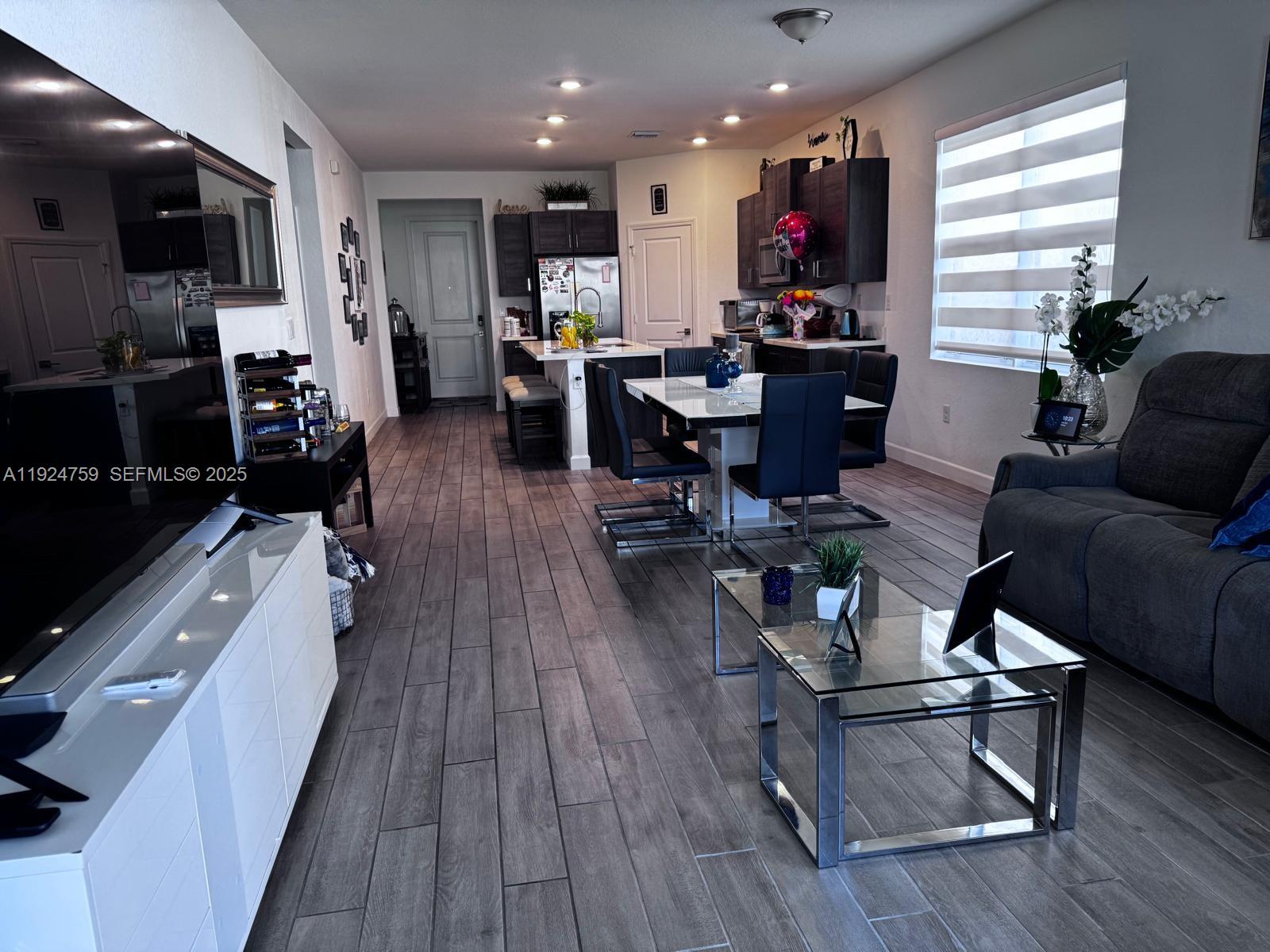 13201 Southwest 269th Terrace Homestead, FL 33032 - Photo 7 of 33 a living room with stainless steel appliances furniture and a wooden floor