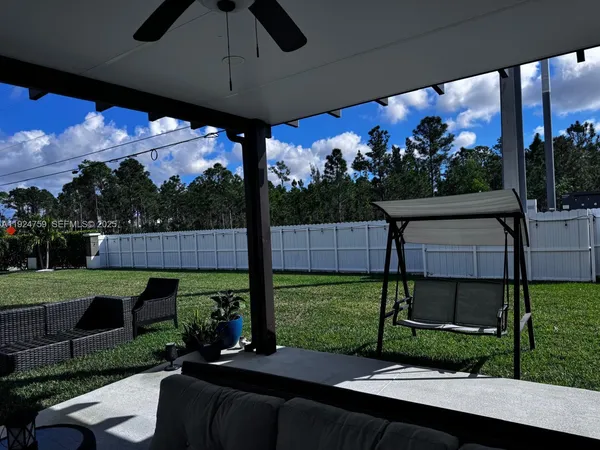 a view of a porch with furniture and garden