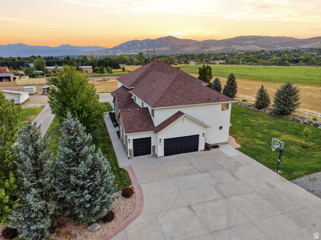 702 Alpine Highway Alpine, UT 84004 - Photo 9 of 83 Spacious property featuring a large concrete driveway, two-car garage, and stone accents