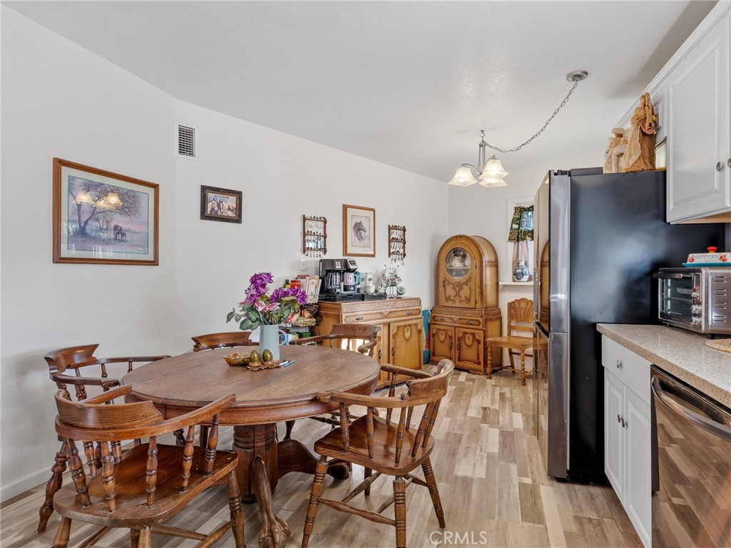 22977 El Centro Road Apple Valley, CA 92307 - Photo 15 of 30 a view of a dining room with furniture and a chandelier