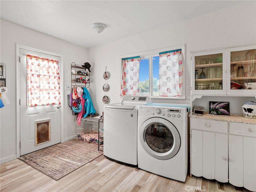 22977 El Centro Road Apple Valley, CA 92307 - Photo 16 of 30 a utility room with sink dryer and washer