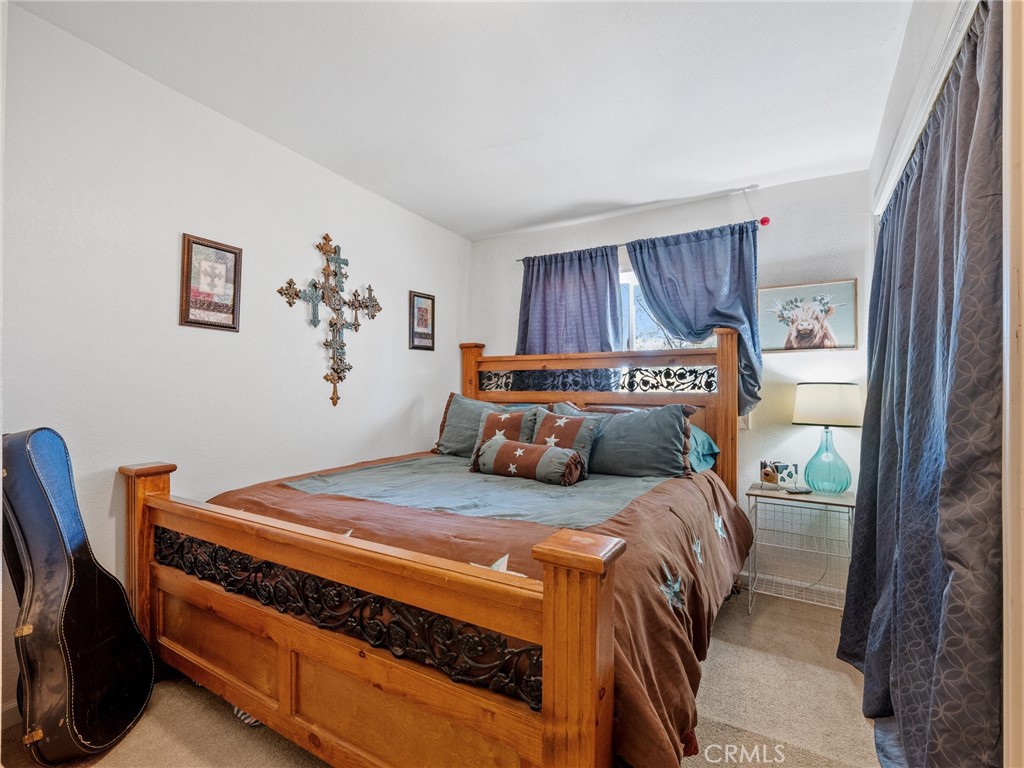 22977 El Centro Road Apple Valley, CA 92307 - Photo 17 of 30 a bedroom with a bed and a dresser next to a window