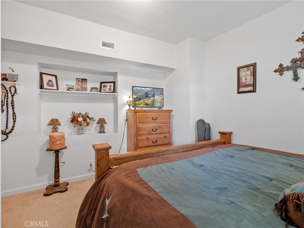 22977 El Centro Road Apple Valley, CA 92307 - Photo 18 of 30 a bedroom with a bed and a dresser