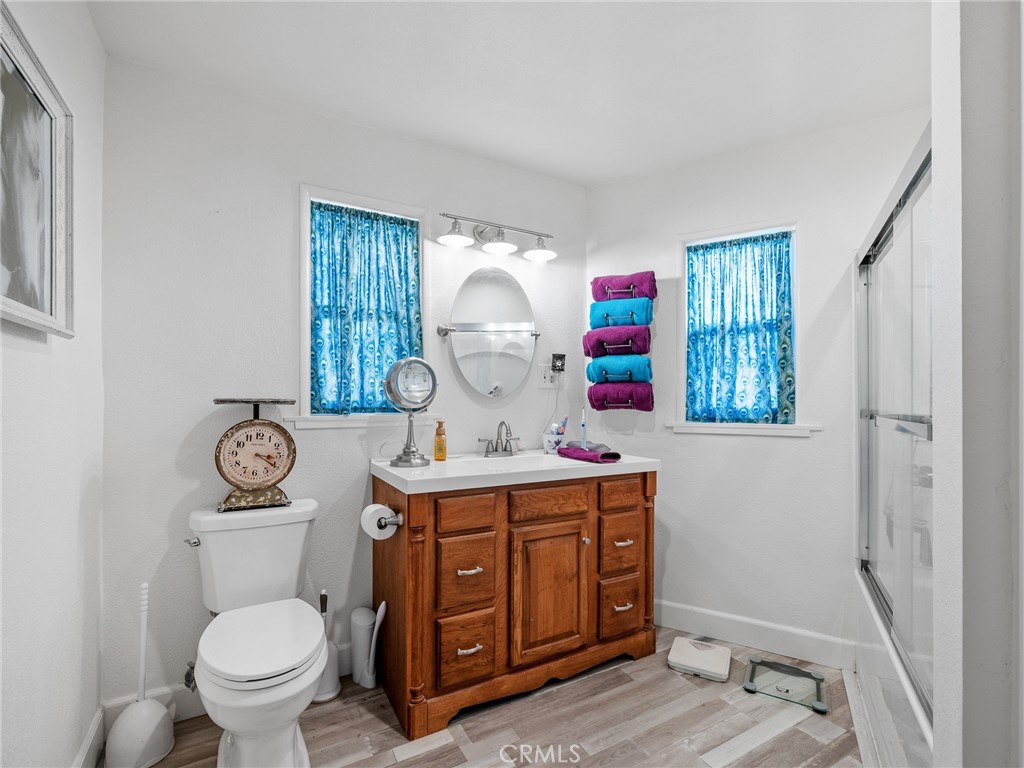 22977 El Centro Road Apple Valley, CA 92307 - Photo 23 of 30 a view of bathroom with a toilet a sink and a window