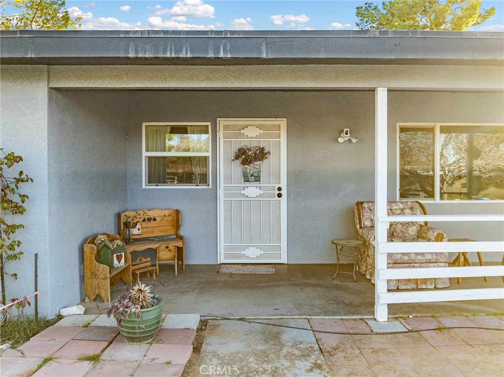 22977 El Centro Road Apple Valley, CA 92307 - Photo 3 of 30 a front view of a house with outdoor seating