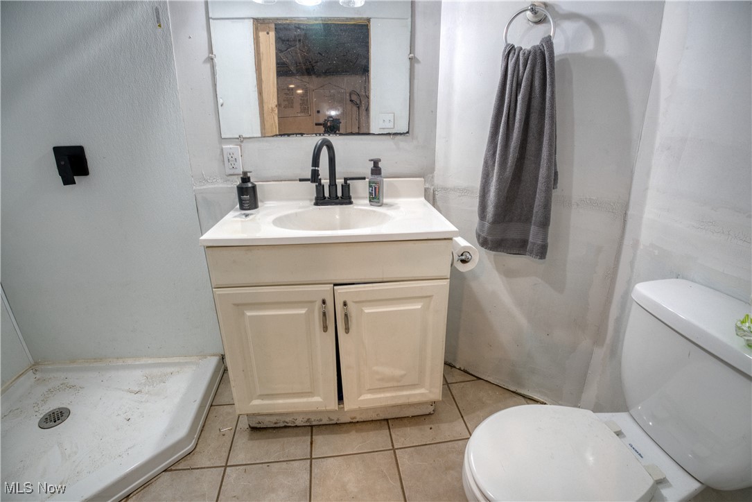 2161 Canton Road Akron, OH 44312 - Photo 28 of 33 Full bathroom featuring a shower, vanity, and tile patterned flooring