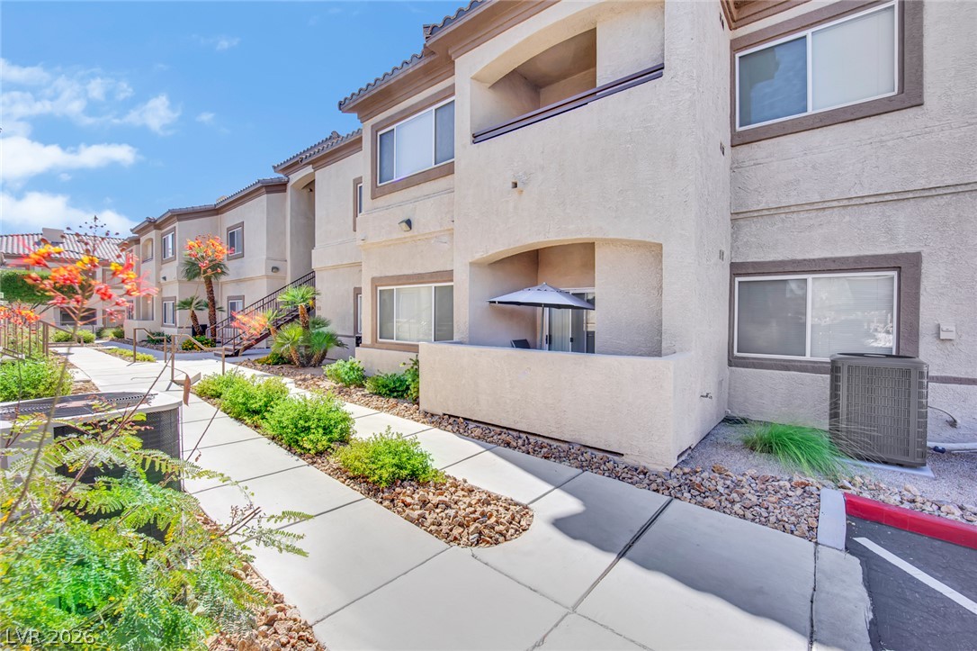 8725 West Flamingo Road, Unit 110 Las Vegas, NV 89147 - Photo 28 of 30 A well-maintained stucco exterior features multiple balconies and lush landscaping, creating an inviting community.