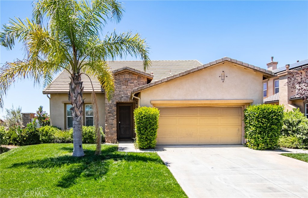 a front view of a house with a garden and plants