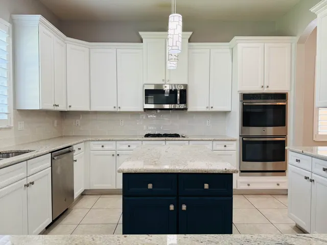 a spacious bedroom with a bed and wooden floor