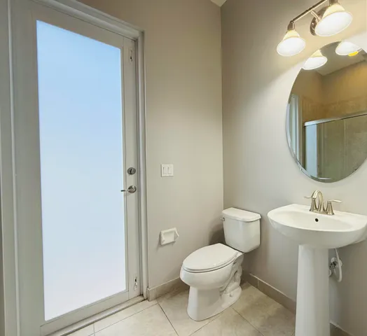a spacious bathroom with a tub sink shower and mirror