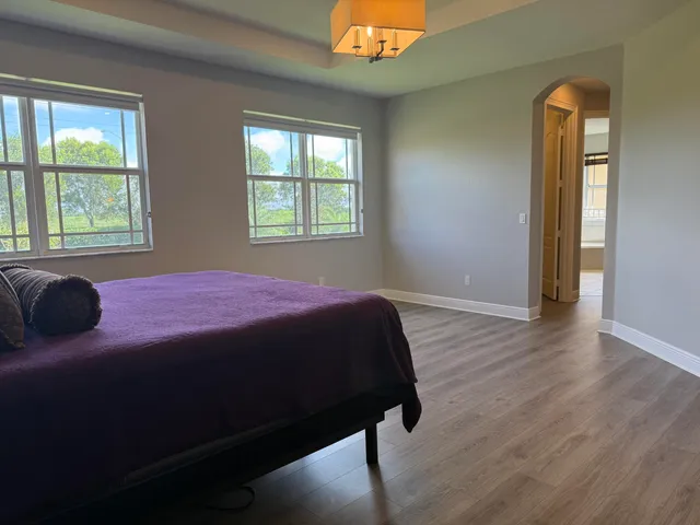 a view of wooden floor and windows in an empty room