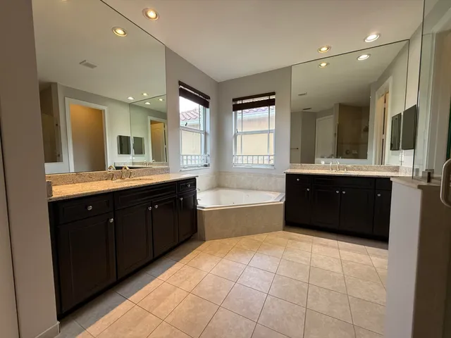 a spacious bedroom with a bed and a window