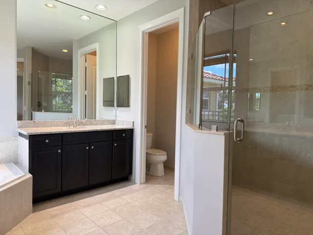 a view of a house with a big yard and large trees