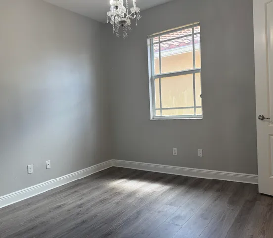 a view of staircase with a table and a chandelier