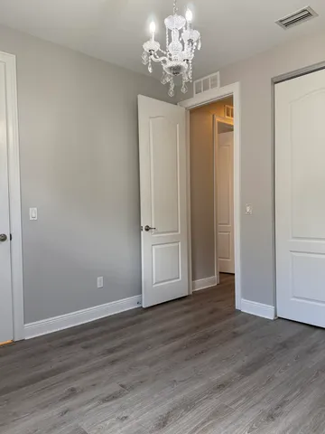 a living room with patio furniture and a floor to ceiling window
