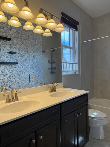 a view of a house with a yard and potted plants