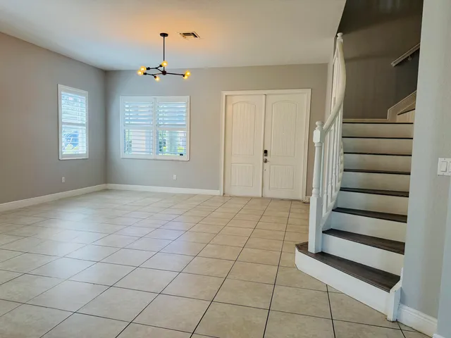 a large kitchen with stainless steel appliances granite countertop a refrigerator and a stove