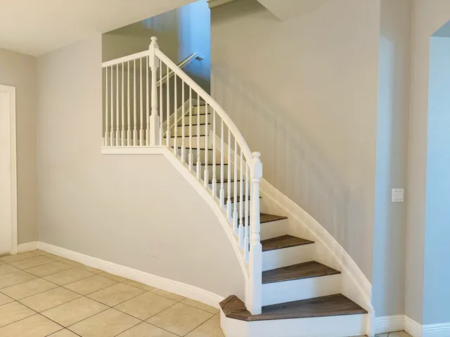 a kitchen with granite countertop white cabinets and stainless steel appliances