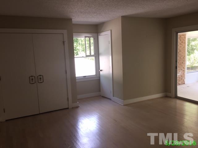 9404 Wilkins Road Bahama, NC 27503 - Photo 14 of 21 an empty room with wooden floor closet and windows