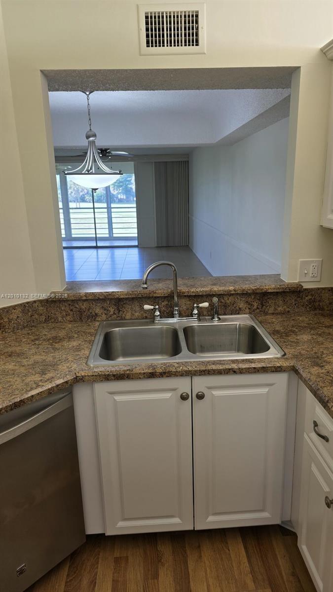 23305 Barwood Lane North, Unit 207 Boca Raton, FL 33428 - Photo 12 of 27 a kitchen with a sink a stove and cabinets