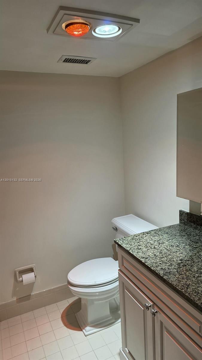 23305 Barwood Lane North, Unit 207 Boca Raton, FL 33428 - Photo 13 of 27 a bathroom with a granite countertop toilet and a sink