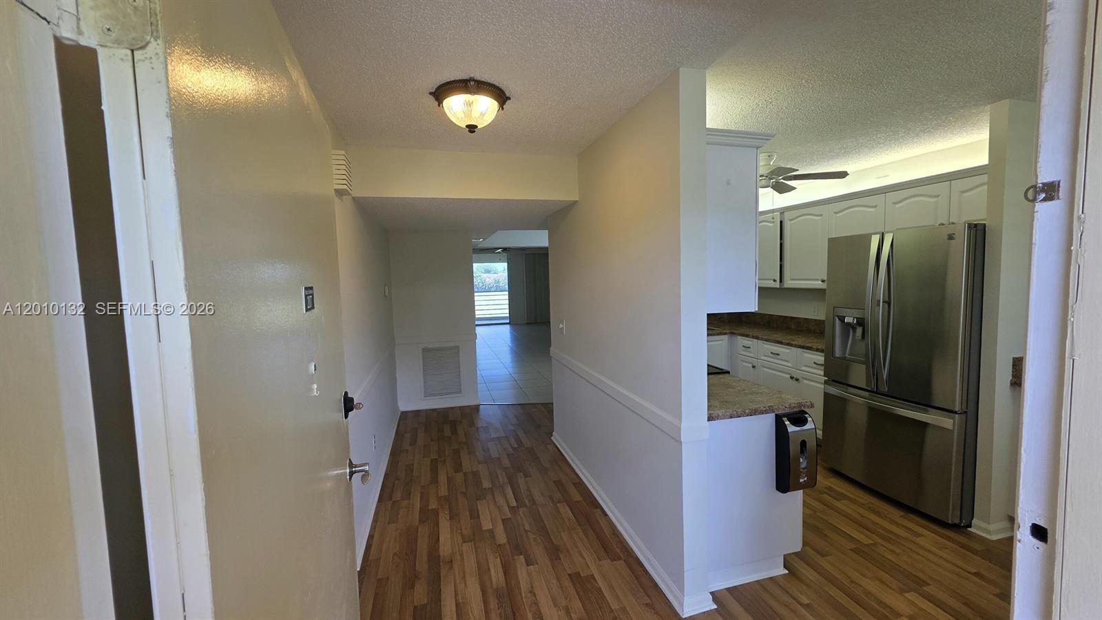 23305 Barwood Lane North, Unit 207 Boca Raton, FL 33428 - Photo 17 of 27 a view of a hallway with wooden floor
