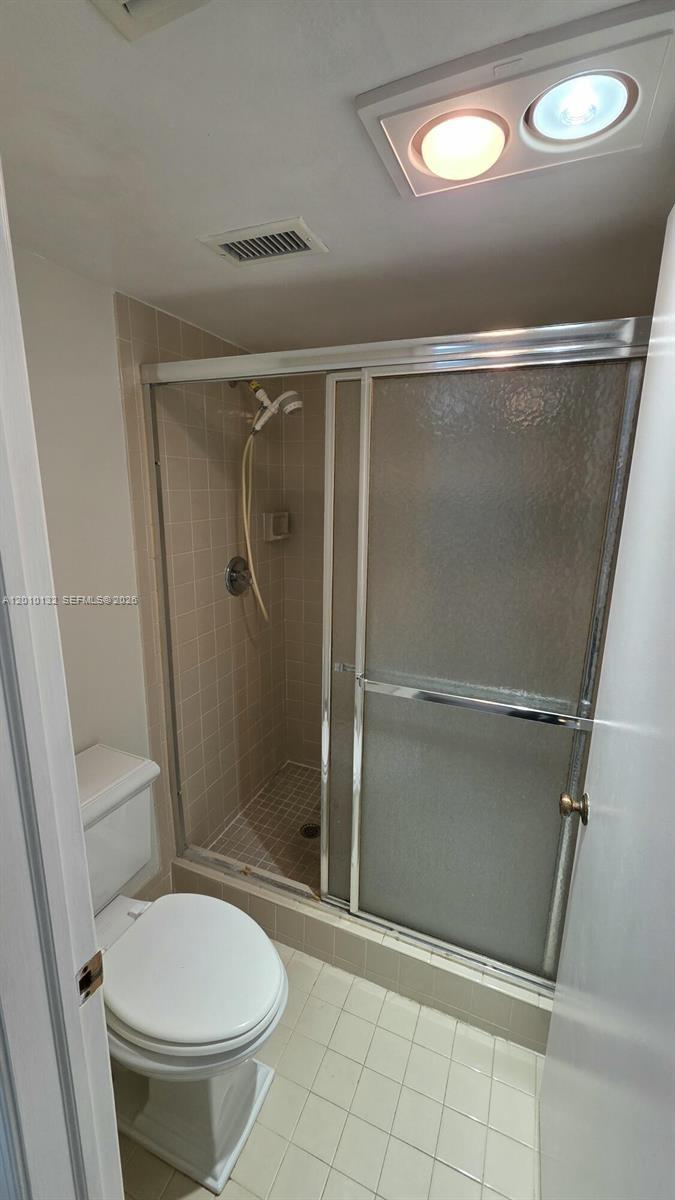 23305 Barwood Lane North, Unit 207 Boca Raton, FL 33428 - Photo 19 of 27 a bathroom with a shower and a toilet