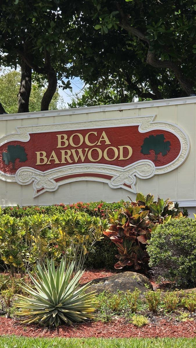 23305 Barwood Lane North, Unit 207 Boca Raton, FL 33428 - Photo 2 of 27 a sign that is on a street