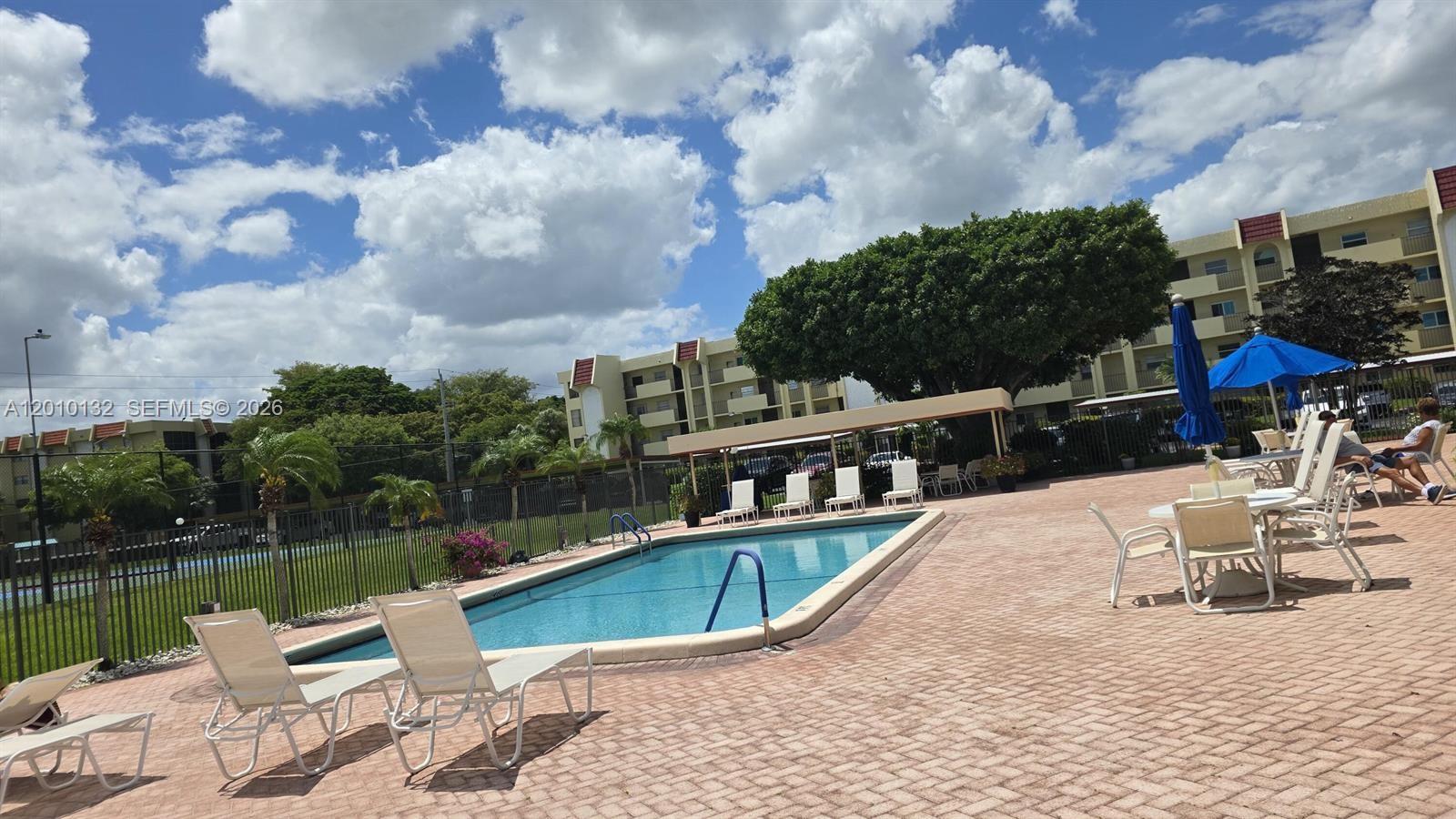 23305 Barwood Lane North, Unit 207 Boca Raton, FL 33428 - Photo 4 of 27 a view of a lake with a house
