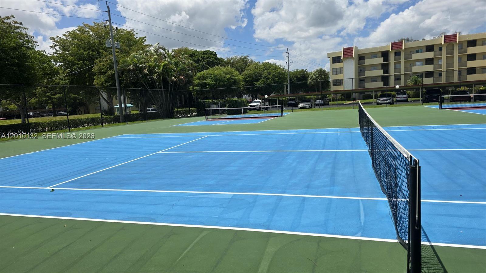 23305 Barwood Lane North, Unit 207 Boca Raton, FL 33428 - Photo 5 of 27 a view of an outdoor space and tennis court
